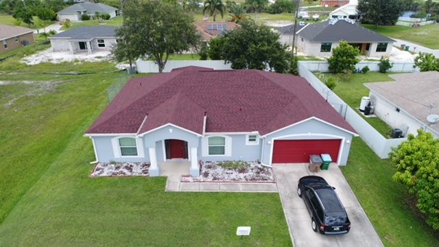 An aerial view of a house with a red roof