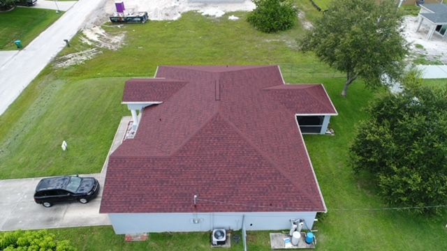 An aerial view of a house with a red roof.