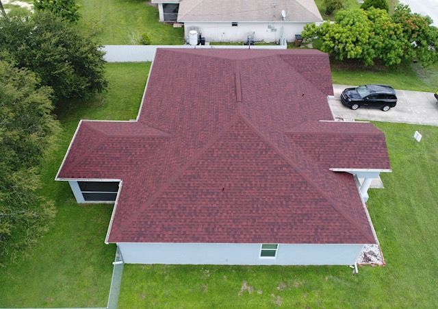 An aerial view of a house with a red roof.