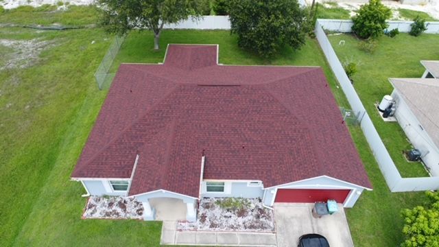 An aerial view of a house with a red roof.