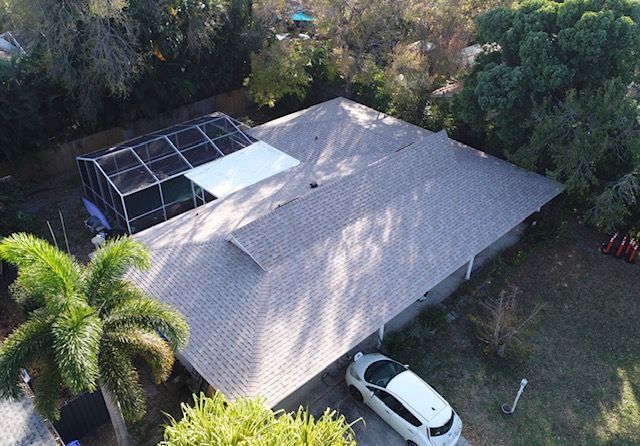 An aerial view of a house with a car parked in front of it.