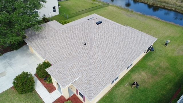 An aerial view of a house with a new roof.