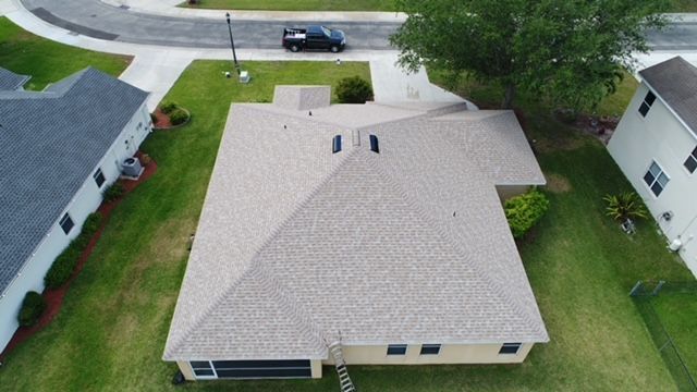 An aerial view of a house with a new roof.