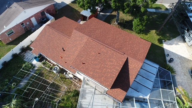 An aerial view of a house with a red roof