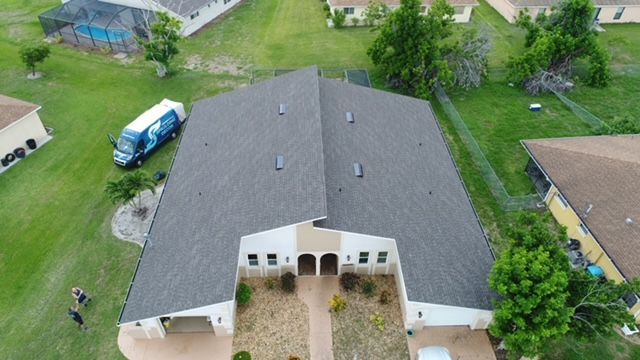 An aerial view of a house with a truck parked in front of it.