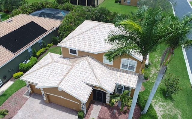 An aerial view of a house with solar panels on the roof.