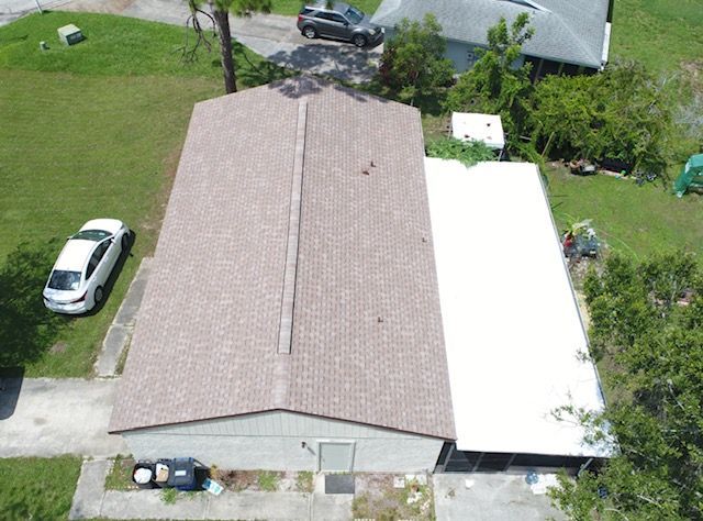 An aerial view of a house with a car parked in front of it.