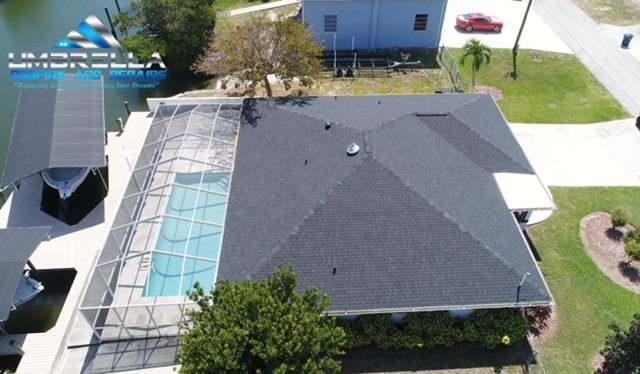 An aerial view of a house with a swimming pool