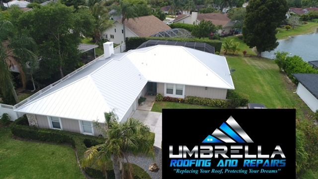 An aerial view of a house with an umbrella roofing and repairs logo