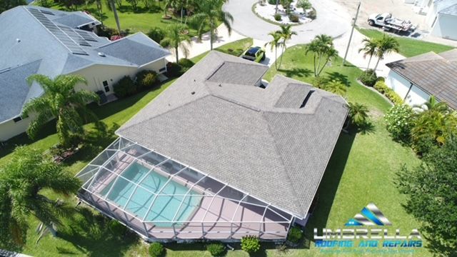 An aerial view of a house with a screened in pool