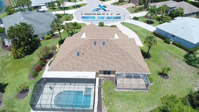 An aerial view of a house with a pool in the backyard.