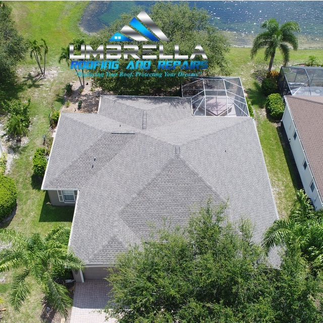 An aerial view of a house that says umbrella roofing and repairs