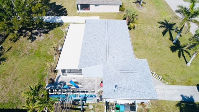 An aerial view of a house with a roof that is being installed.