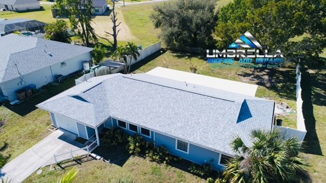 An aerial view of a house with an umbrella logo on the roof