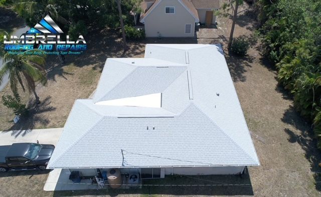 An aerial view of a house with a white roof.
