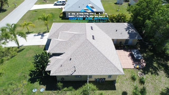 An aerial view of a house with a gray roof