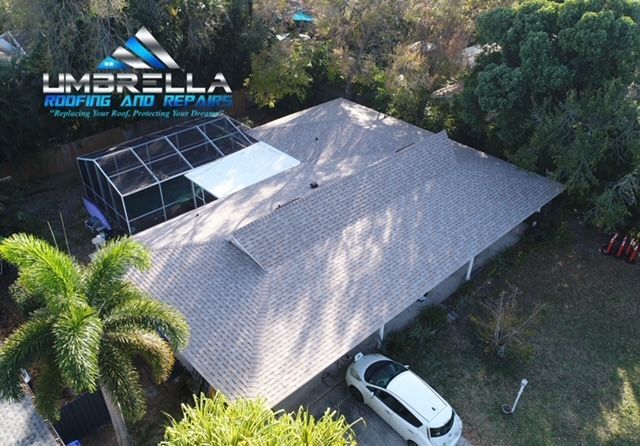 An aerial view of a house with a car parked in front of it.