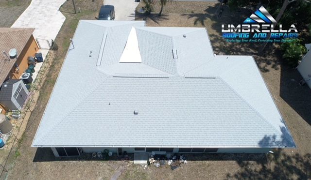An aerial view of a house with a white roof.