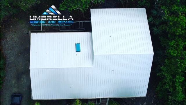 An aerial view of a white building with the word umbrella on it