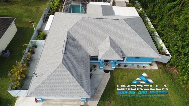 An aerial view of a house with a gray roof