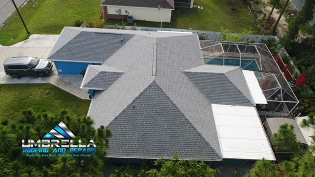 An aerial view of a house with a roof and a pool.