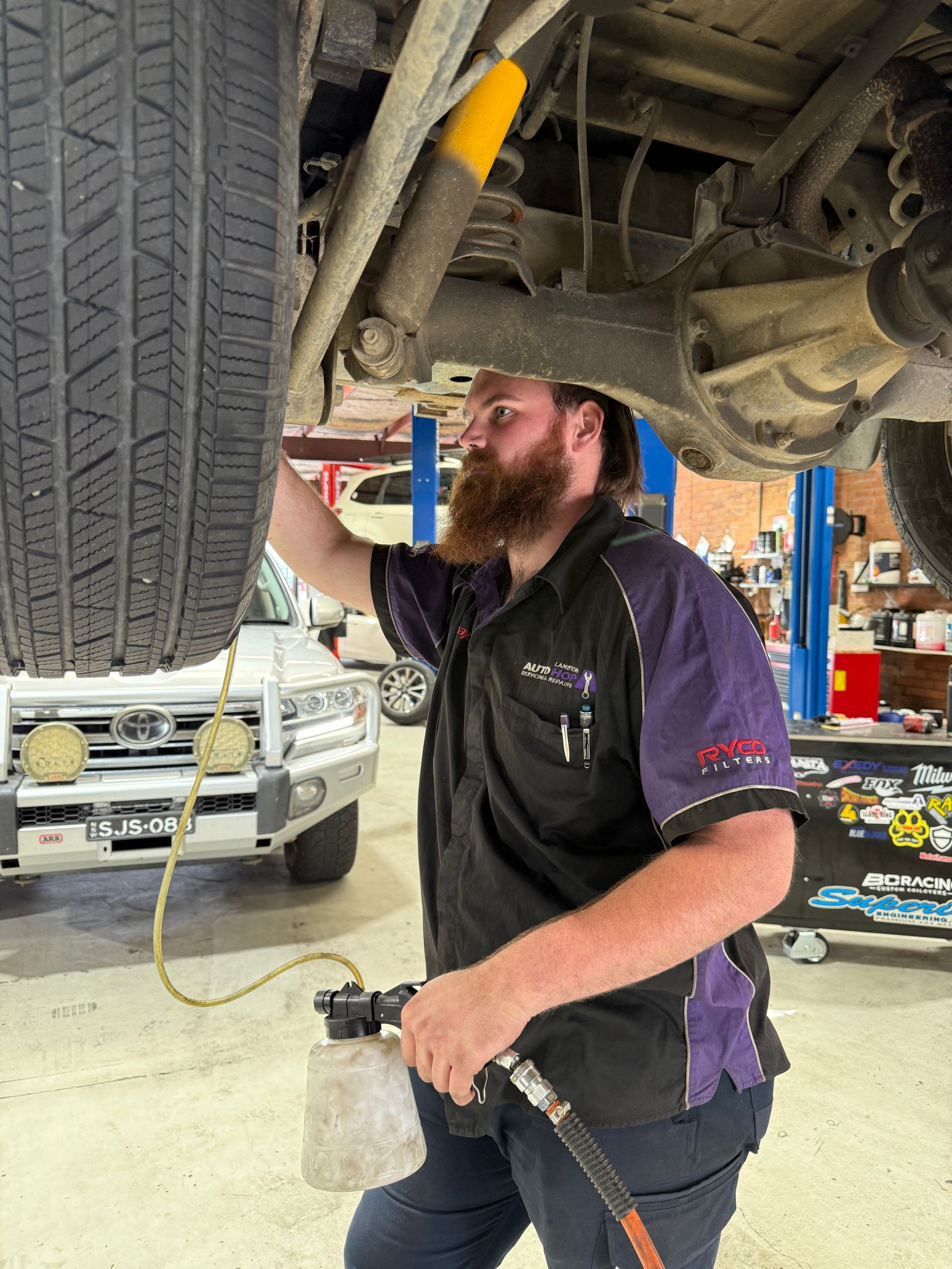Mechanic Changing a Tire in A Workshop — AutoHop Lambton in Lambton, NSW