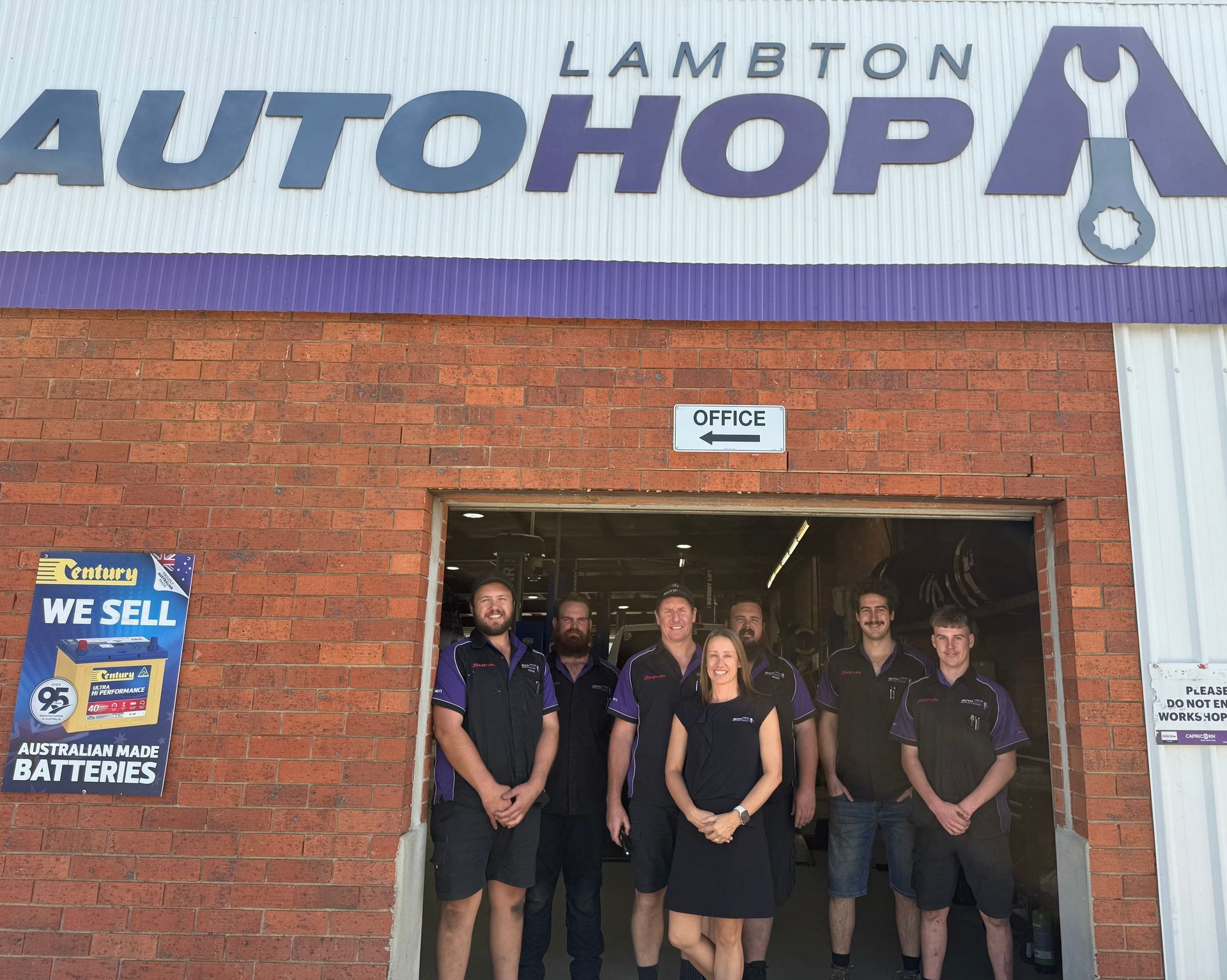 Six Mechanics Pose in A Garage, Leaning on Tool Chests — AutoHop Lambton in Lambton, NSW