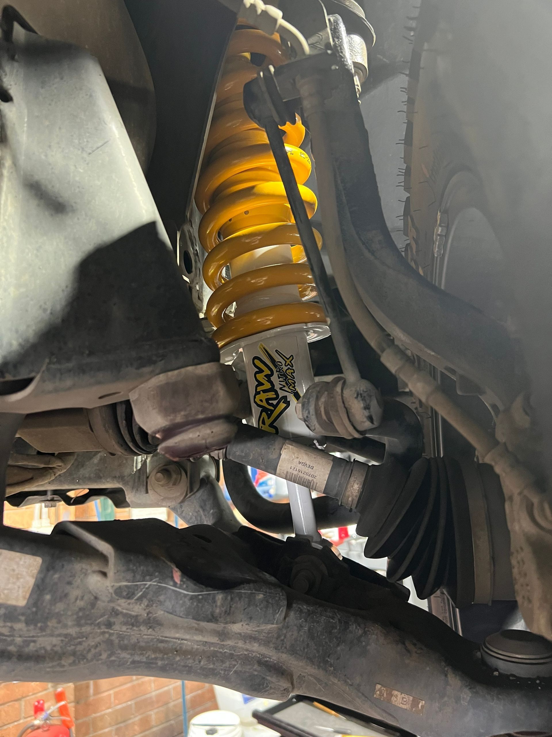 Yellow Shock Absorber in A Vehicle Suspension System — AutoHop Lambton in Lambton, NSW