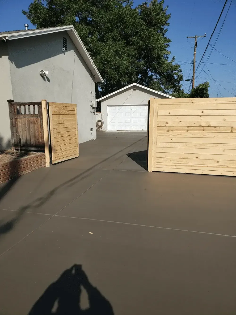 A wooden fence is sitting in front of a house.