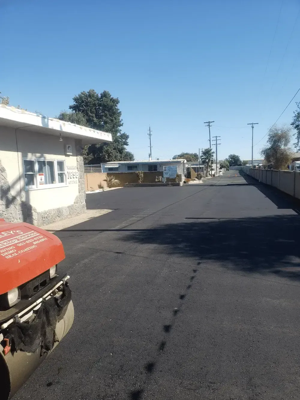 A red truck is parked on the side of a road.