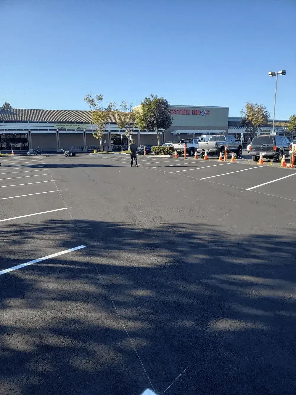 A parking lot with cars parked in front of a store.