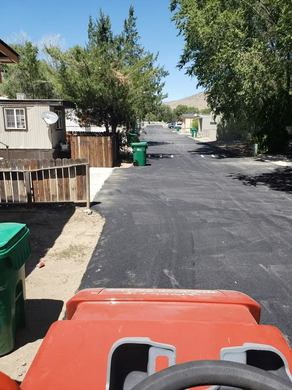 A red tractor is parked on the side of a road