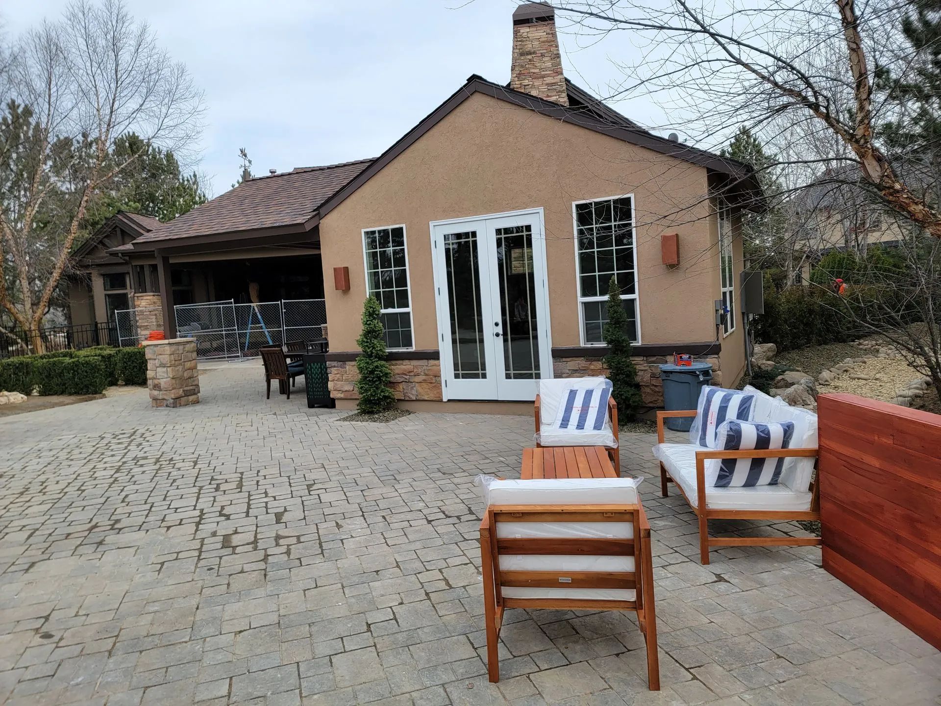 A house with a lot of furniture in front of it