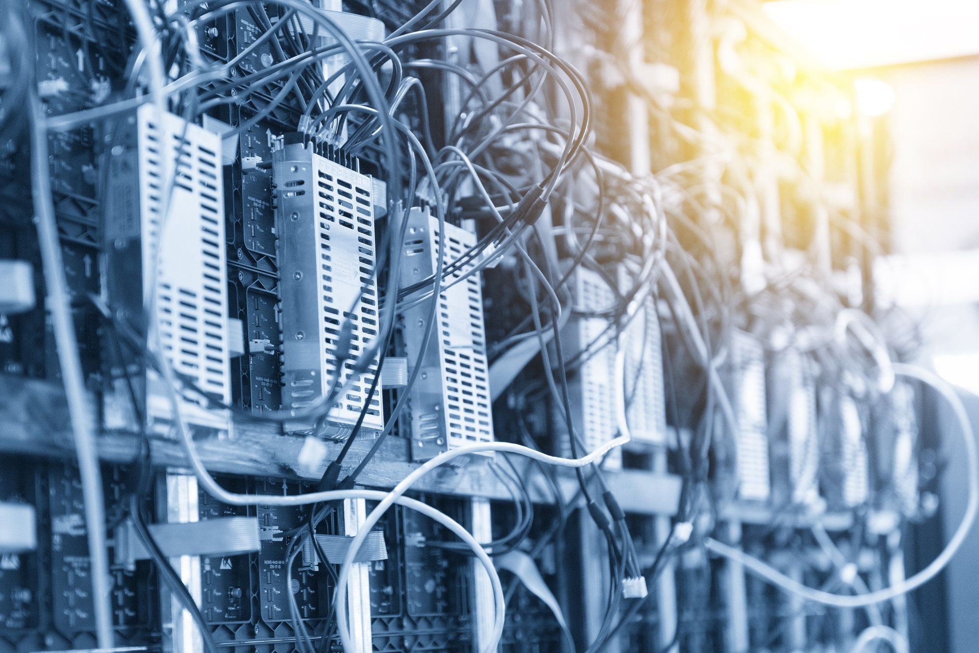 a bunch of wires are connected to a server in a data center