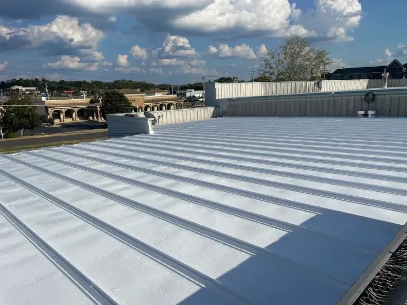 A white roof with a blue sky in the background.