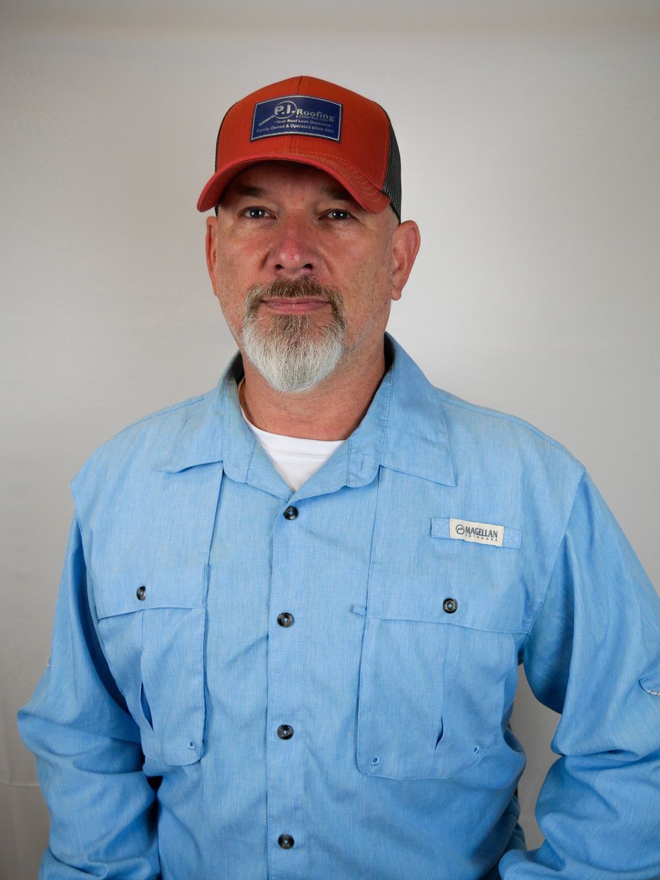 A man wearing a blue shirt and an orange hat