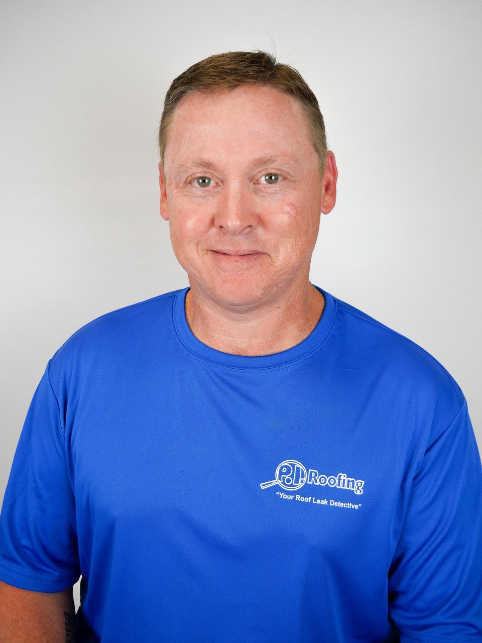 A man wearing a blue shirt with the word housing on it