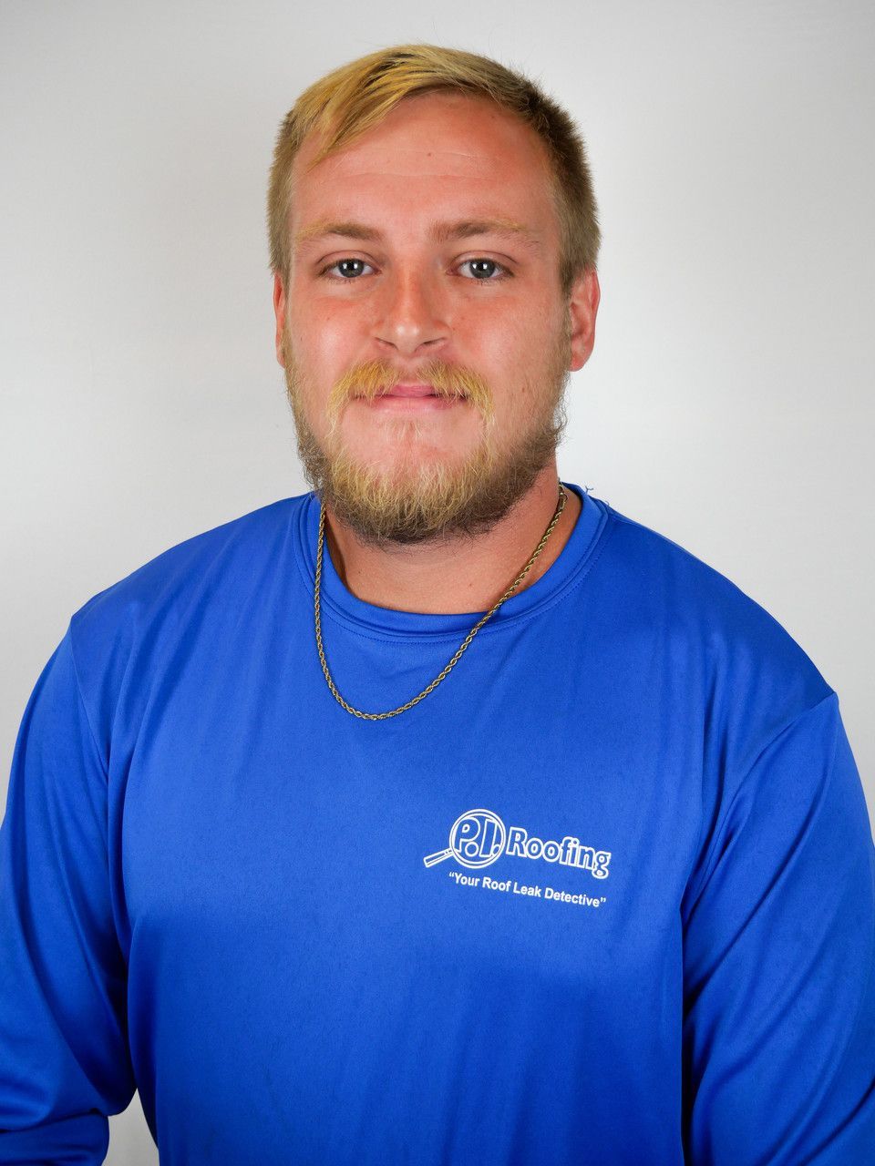 A man with a beard is wearing a blue shirt