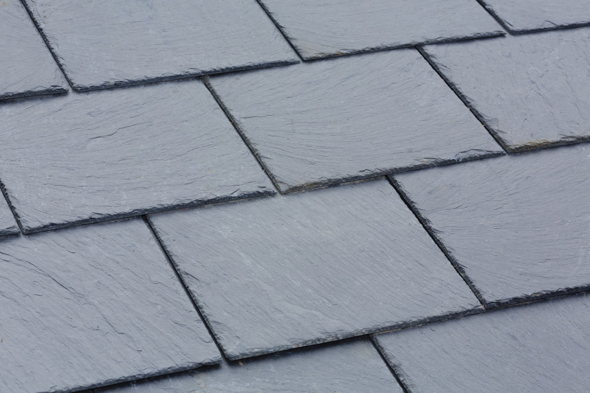 A close up of a roof with square tiles on it