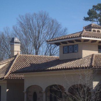 picture of a home with a brown tile roof