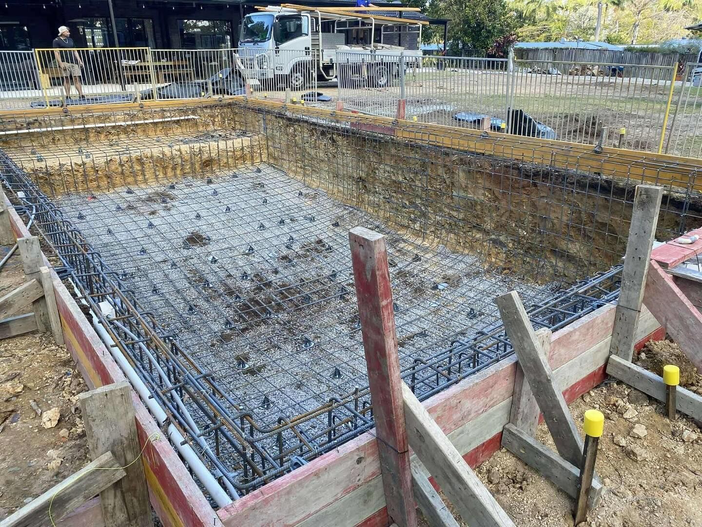 Construction of a rectangular pool, steel reinforcement and wooden formwork in place.