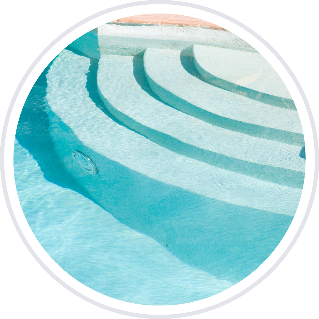 Steps in a clear, blue swimming pool.