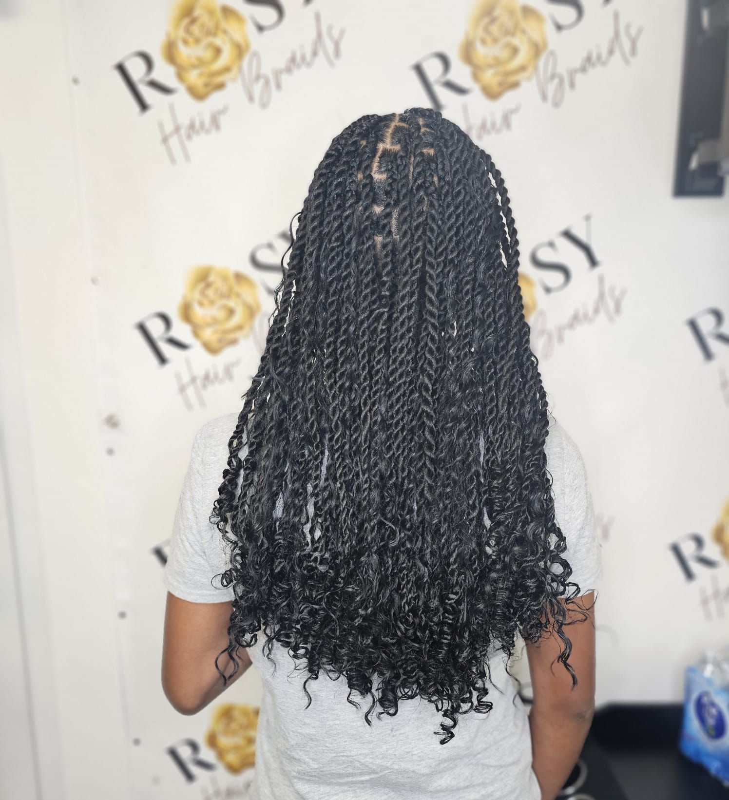 A woman is holding her hair in front of a sign that says ross