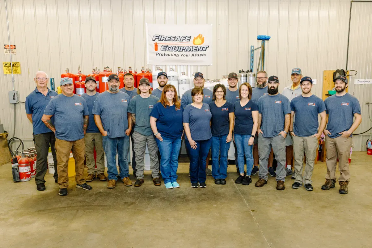 A group of people are posing for a picture in a garage.