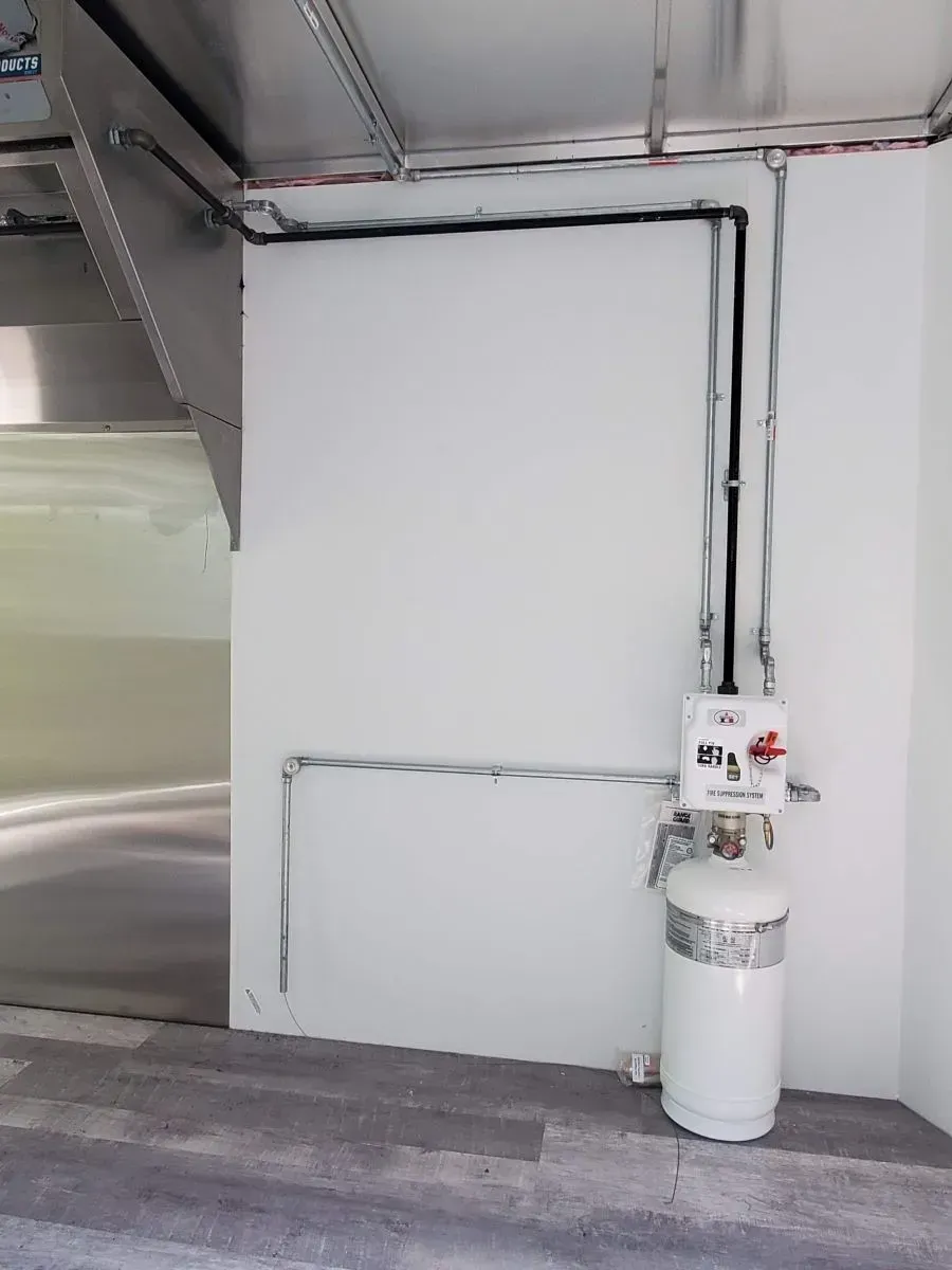 An empty room with a propane tank in the corner