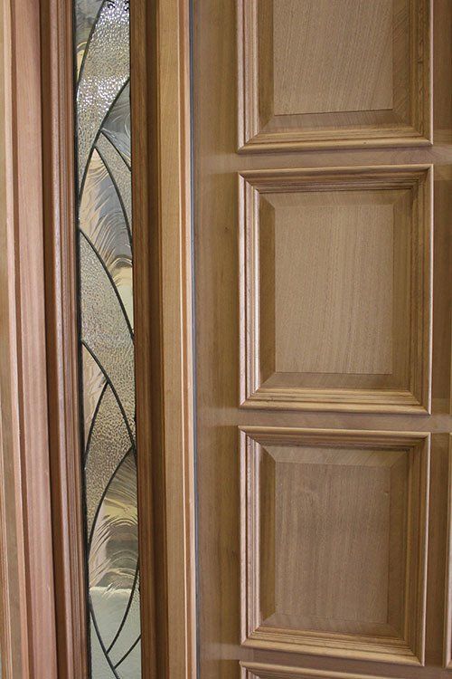 A close up of a wooden door with a stained glass window