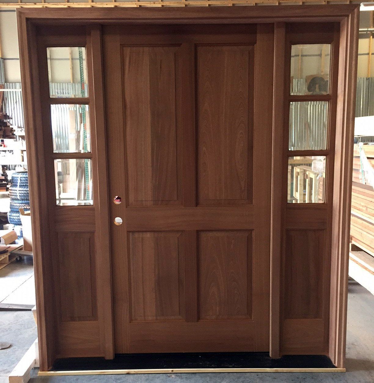 A wooden door with a black mat underneath it