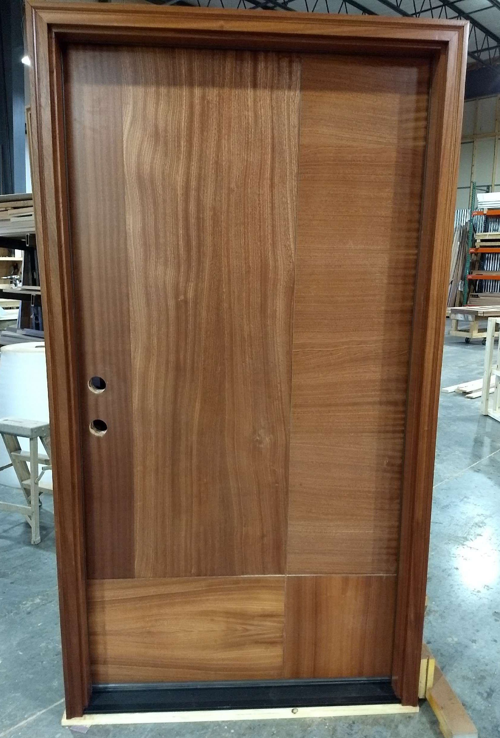 A wooden door is sitting on a table in a warehouse.