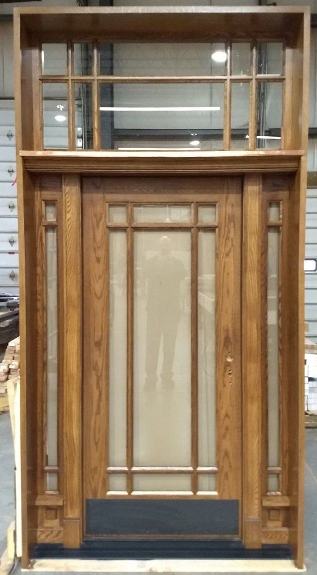 Replicated red oak doors, pre-finished Chappo color Copper clad transom sills Clear laminated glass to control street noise