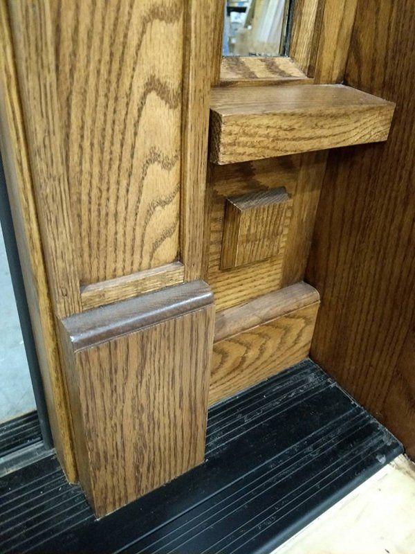 A close up of a wooden door with a mirror on it.